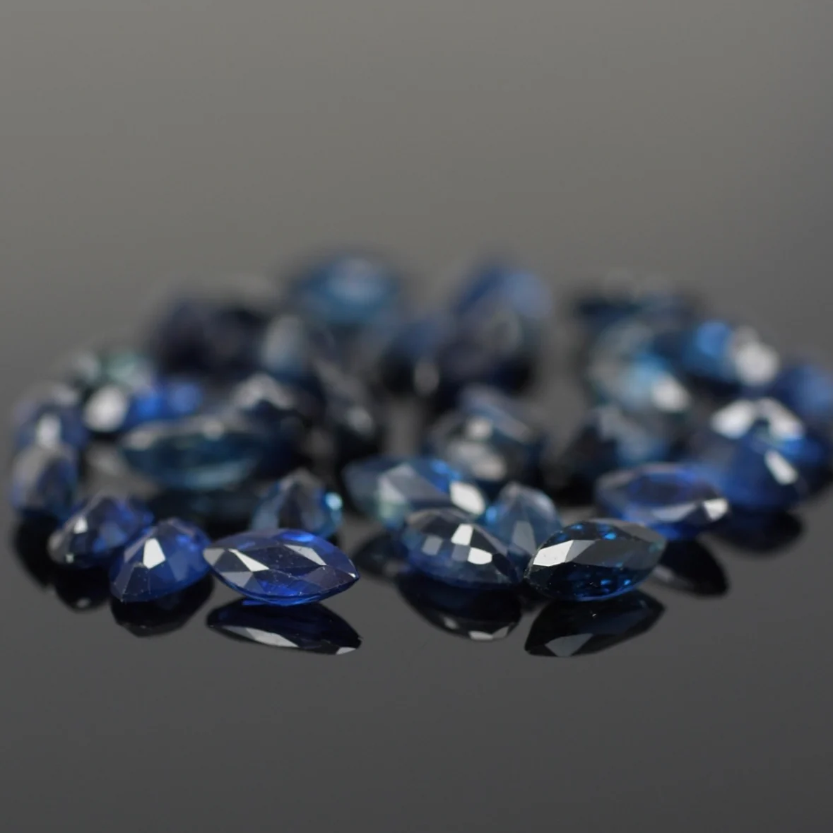 Sapphire | natural, dark blue color, marquise-cut, accent stones