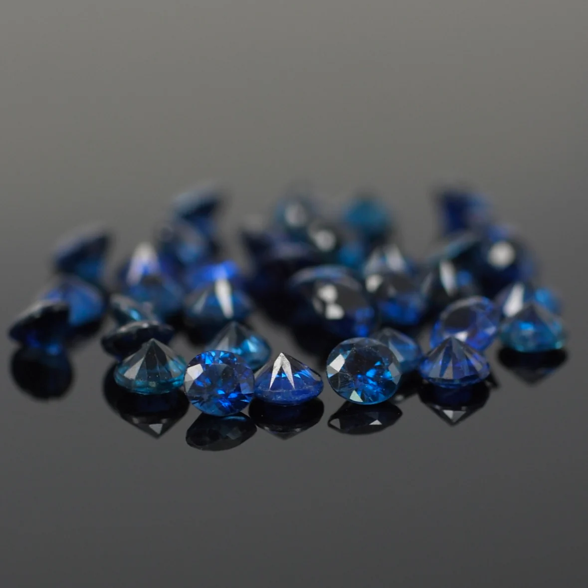 Sapphire | natural, dark blue color, round-cut, accent stones