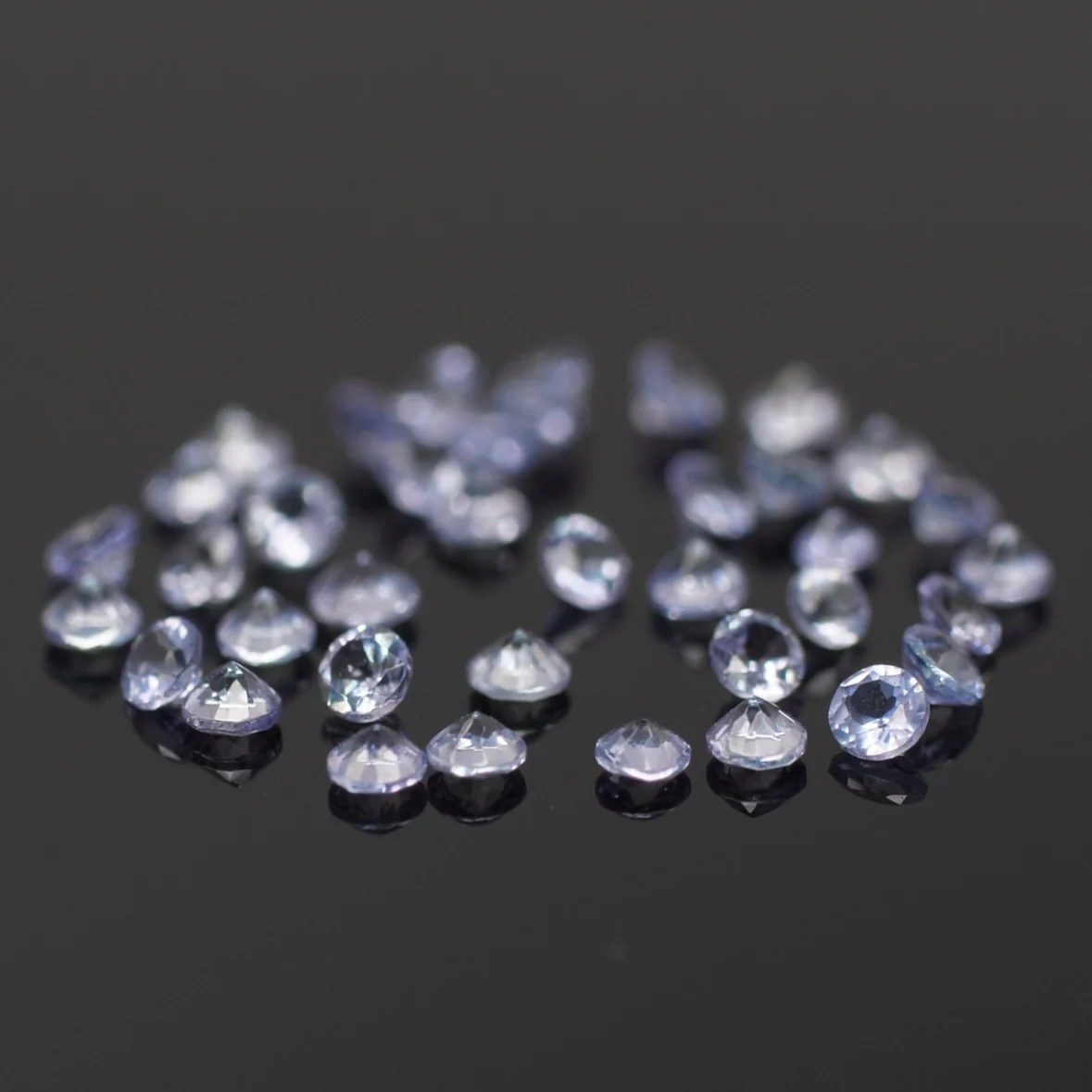 Tanzanite | natural, lavender color, round-cut, accent stones